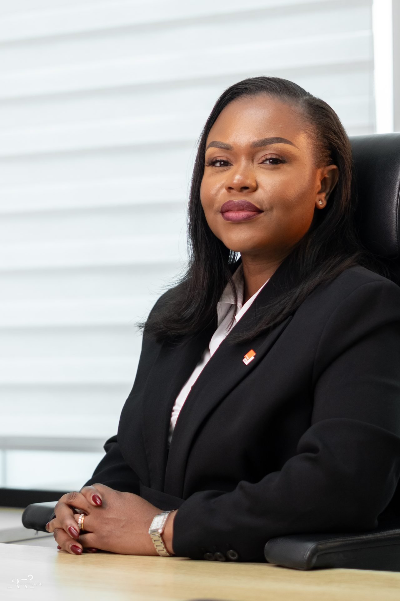 Audrey Koffi Niamkey assise, en plan rapproché, en tenue noire.